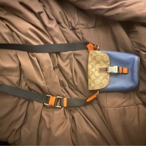 Mini Navy blue with Coach logo , can be crossbody or shoulder purse .